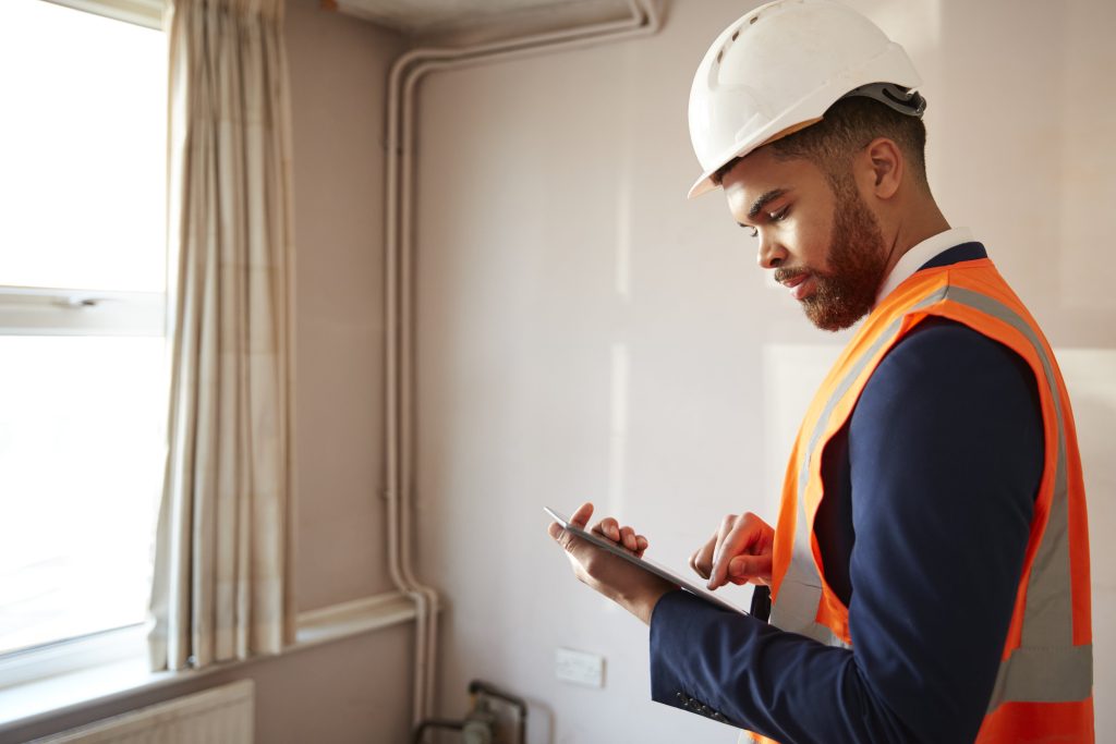 surveyor-in-hard-hat-and-high-visibility-jacket-wi-2021-08-26-16-14-42-utc-min
