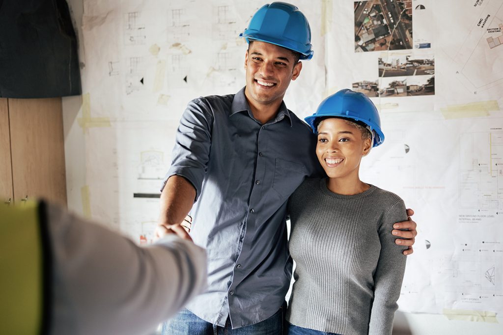 Handshake, construction and couple consulting, planning and doing inspection of home renovation